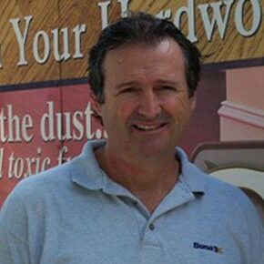 A man standing in front of a sign.