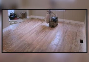 A picture of a room with wood floors and a machine.